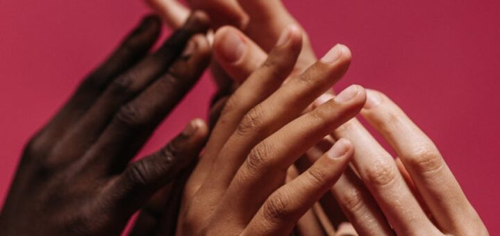 hands touching against red background